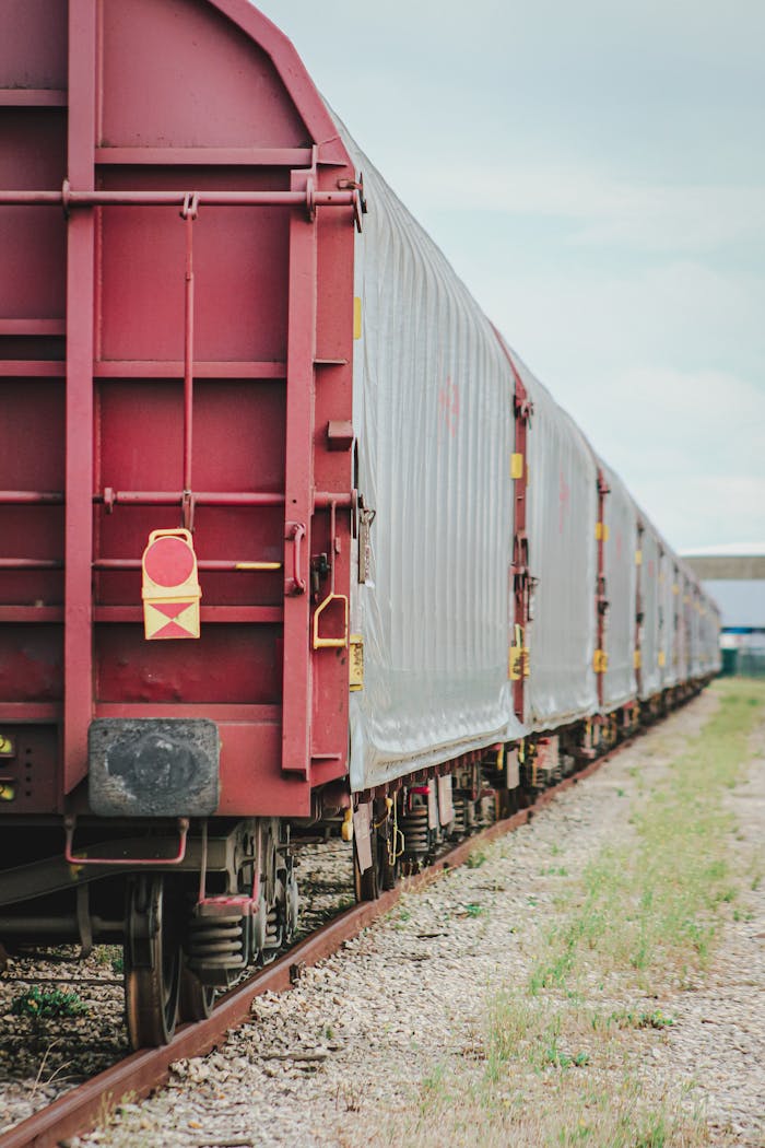 A lengthy freight train captured at a railyard in Arles, Provence, showcasing industrial transport.